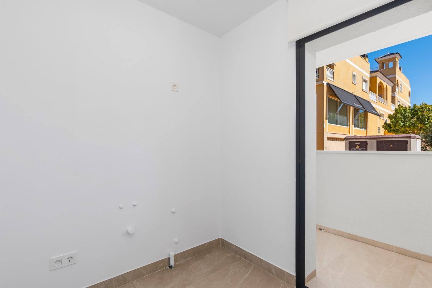 NEW-BUILD-BUILD-RESIDENTIAL-COMPLEX-IN-BENIJOFAR-19 Empty utility room with white walls and tiled floor in a ground floor 4 bedroom apartment in Benijofar