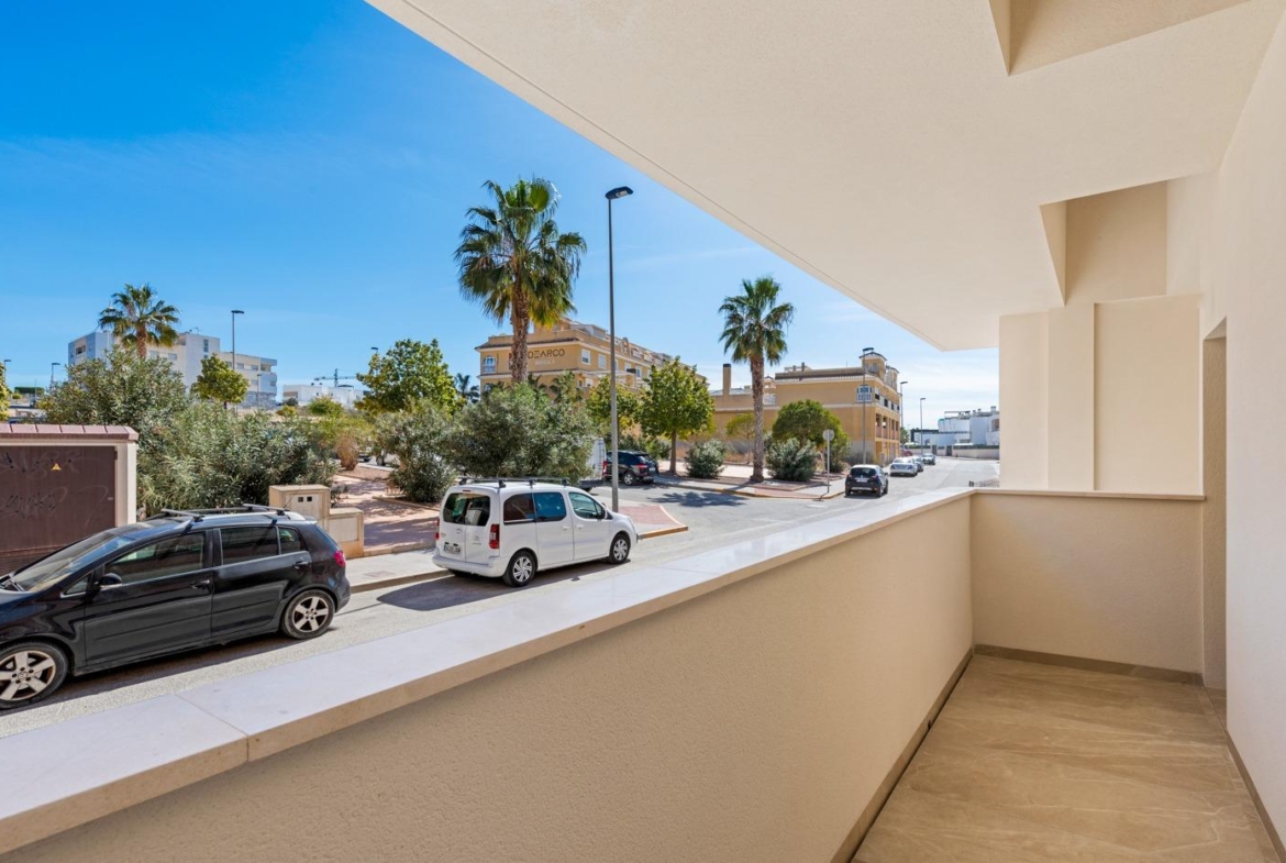 Balcony view overlooking street with palm trees from a new build 4 bedroom ground floor apartment in Benijofar