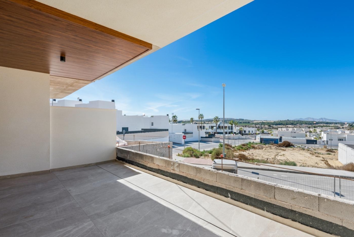 Spacious terrace of a new build 2 bedroom ground floor apartment overlooking Benijofar neighborhood and distant hills.