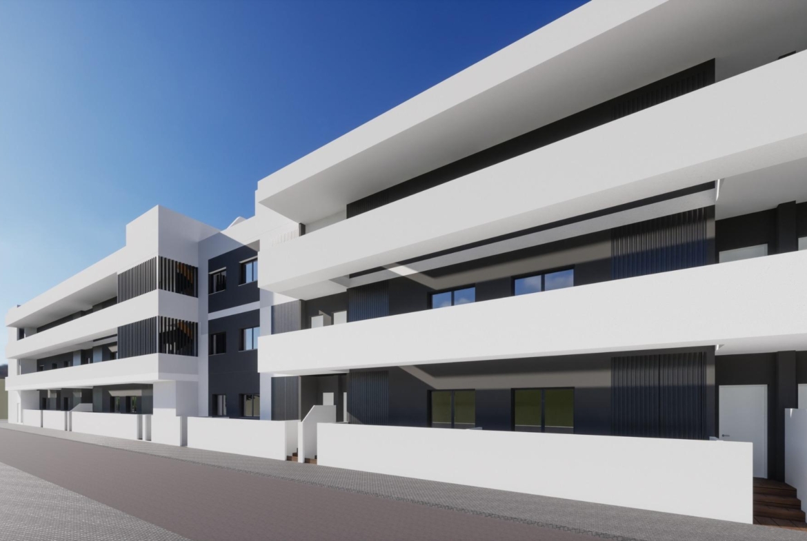 Modern exterior of a new build 3 bedroom ground floor apartment complex in Benijofar under a clear blue sky.