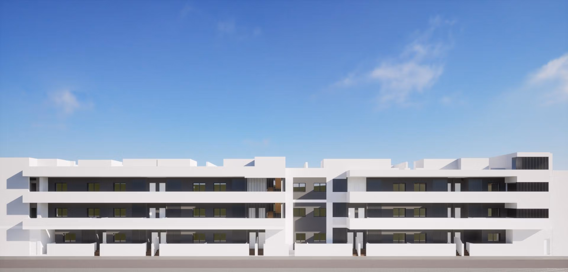 Modern white exterior of a new build 2 bedroom apartment complex under clear blue sky in Benijofar, Alicante