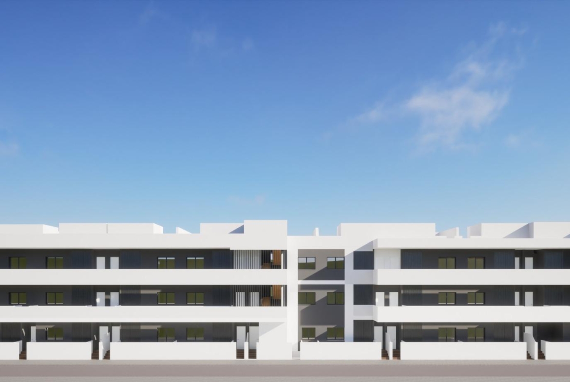 Modern white exterior of a new build 3 bedroom ground floor apartment complex in Benijofar under a clear blue sky.