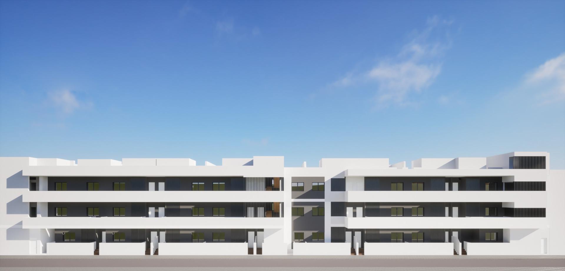 Modern white exterior of a new build 3 bedroom ground floor apartment complex in Benijofar under a clear blue sky.