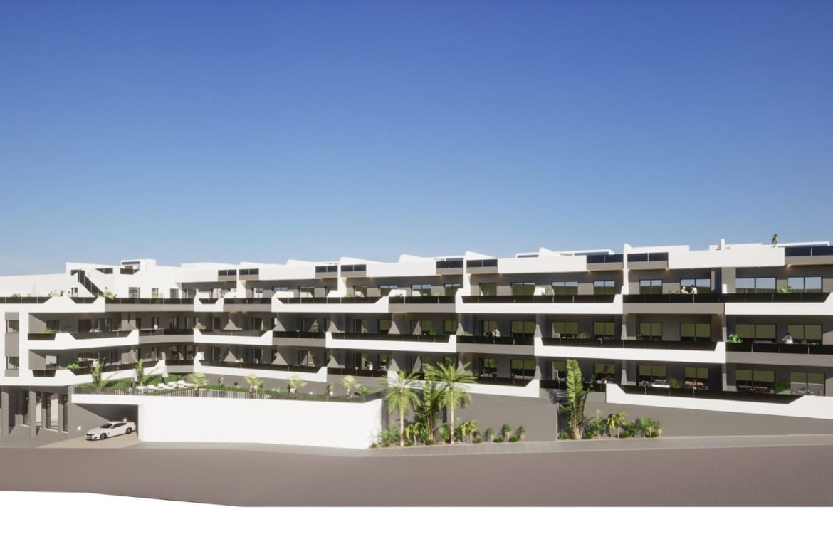 Exterior view of modern new build 3 bedroom apartment complex in Benijofar, Costa Blanca South with balconies and clear sky.