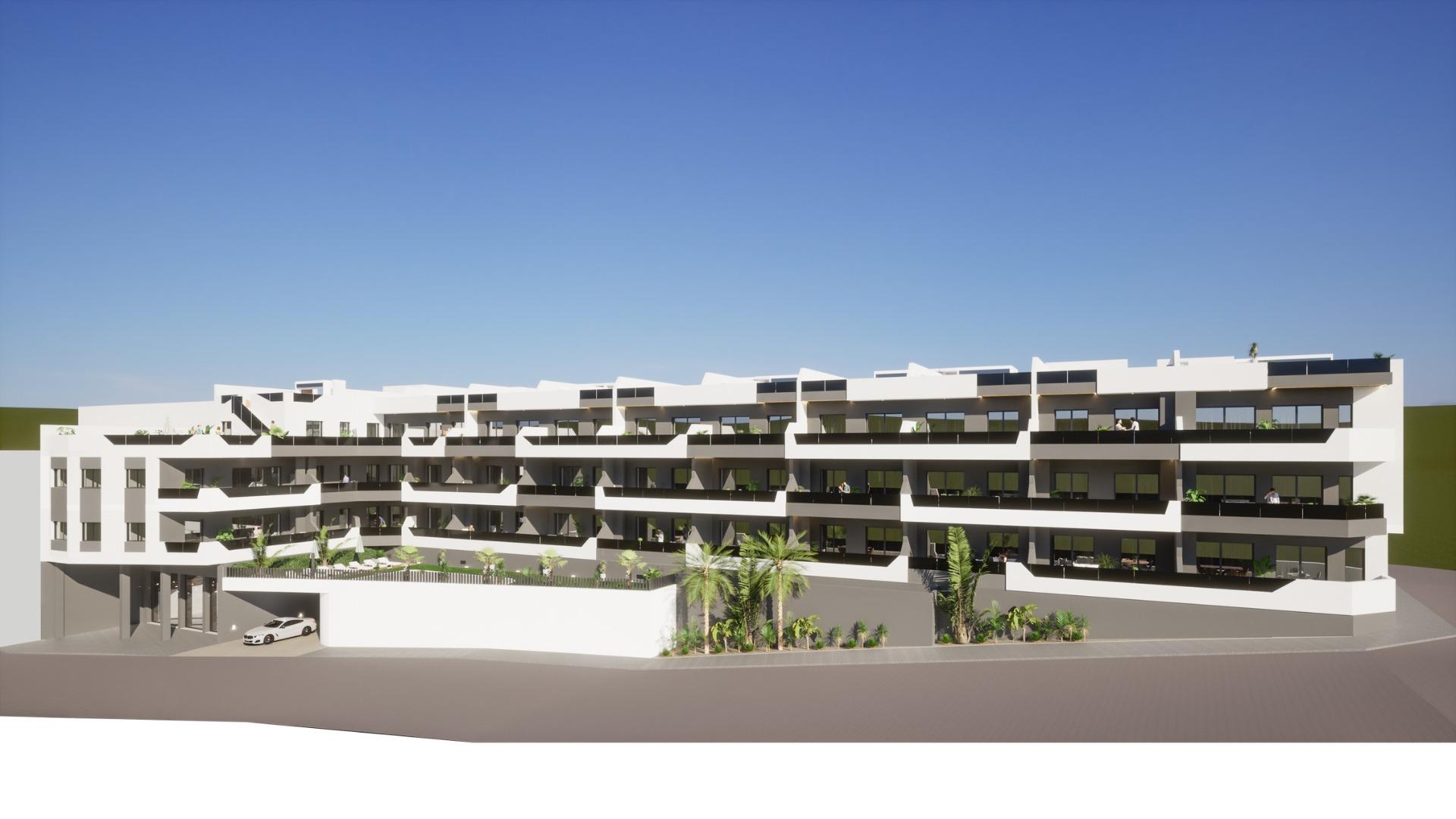 Modern white multi-story apartment building exterior with balconies, representing new 2 bedroom ground floor apartment in Benijofar.