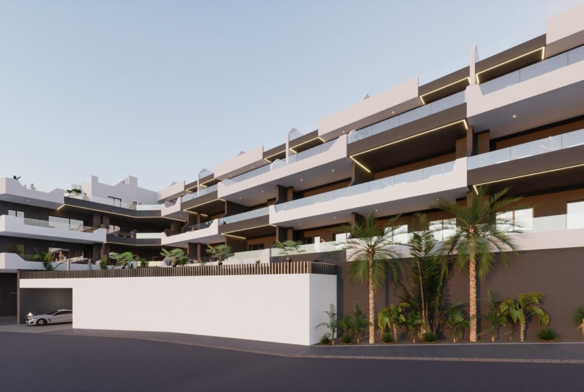 Modern exterior of a bright new build 2 bedroom apartment complex in Benijofar, Alicante with balconies and palm trees.