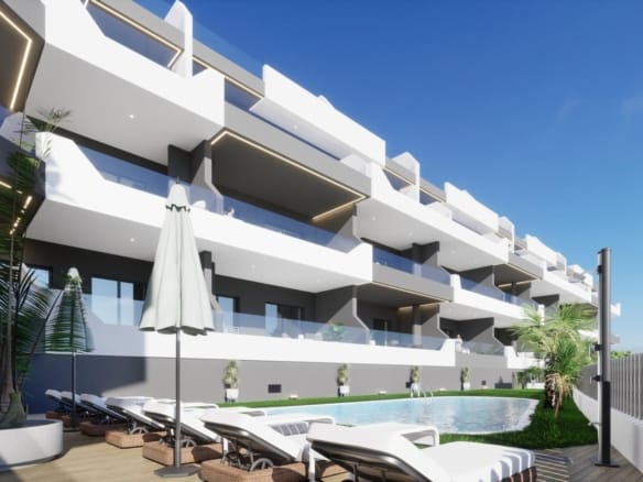 Modern white new build ground floor apartment in Benijofar with spacious terrace and shared swimming pool under clear blue sky