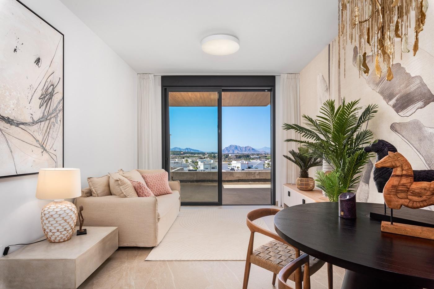 Living room with sofa, dining table, and mountain view terrace in modern 3-bedroom apartment in Benijofar, Costa Blanca South