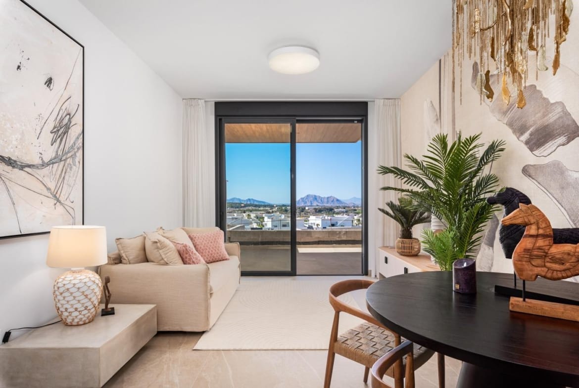 Living room with sofa, dining table, and mountain view in a new build 2 bedroom apartment in Benijofar, Alicante