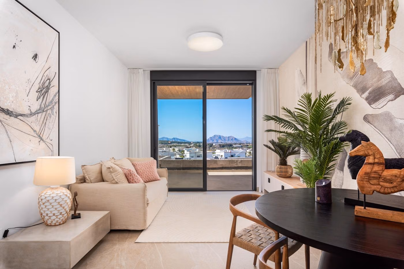 Living room with sofa, dining table, and mountain view in a new build 2 bedroom apartment in Benijofar, Alicante