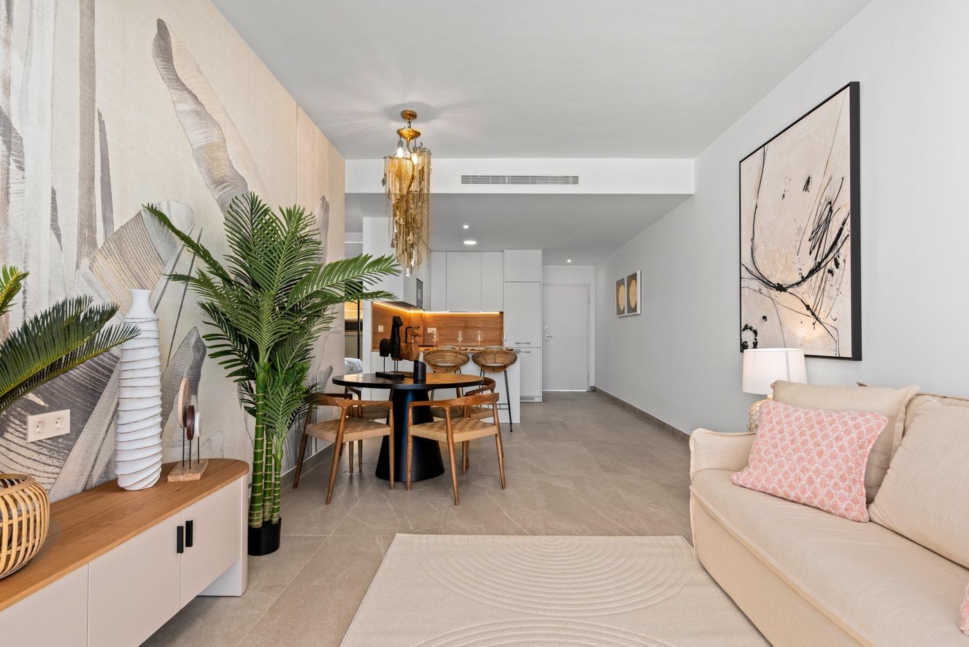 Bright living and dining area with modern kitchen in a 3-bedroom ground floor apartment for sale in Benijofar.