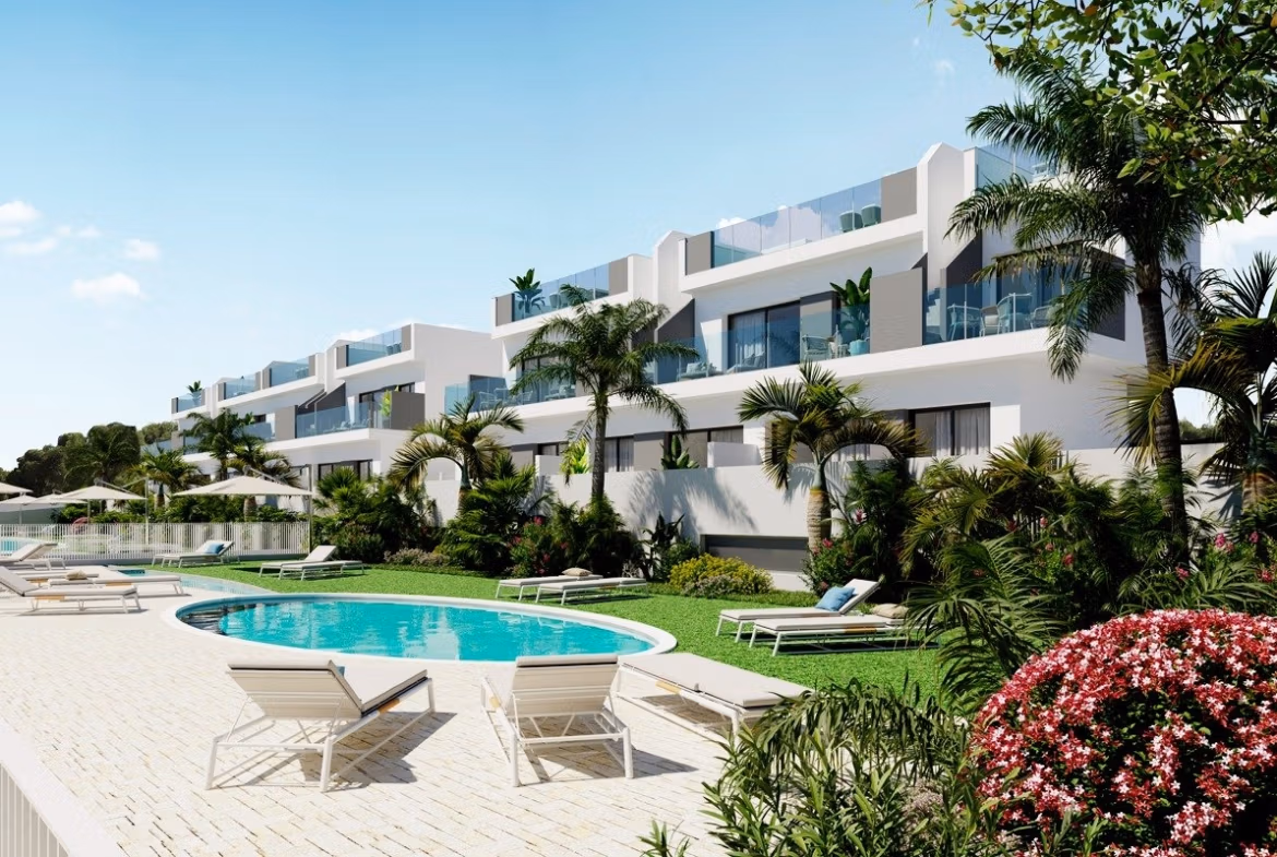 NEW BUILD RESIDENCIAL IN LOS BALCONES Modern top floor apartment complex with pool and sun loungers surrounded by greenery in Los Balcones, Torrevieja.