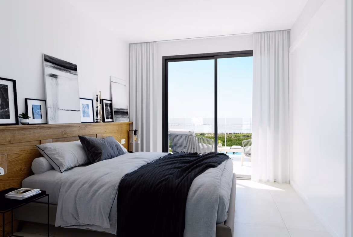 NEW-BUILD-RESIDENCIAL-IN-LOS-BALCONES-TORREVIEJA-4 Top floor bedroom with large sliding doors leading to solarium terrace in Los Balcones apartment, Torrevieja.