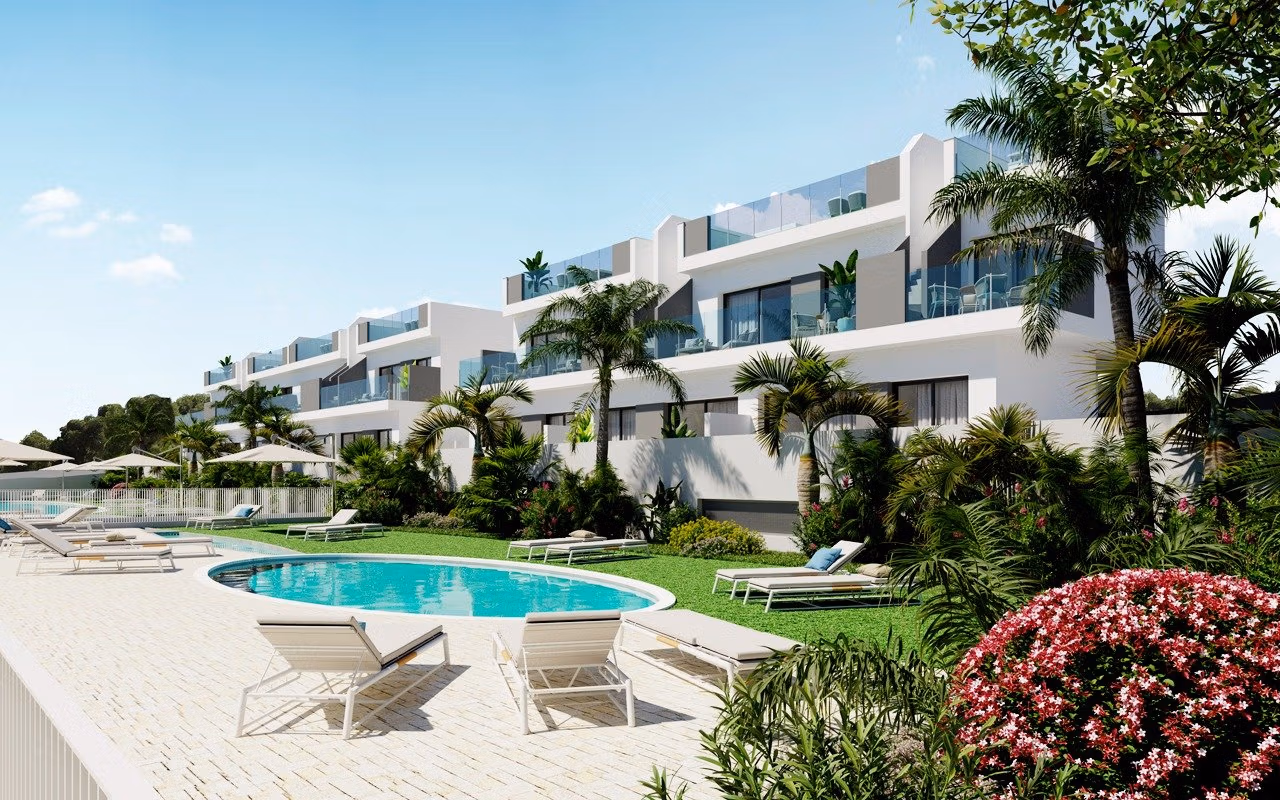 NEW BUILD RESIDENCIAL IN LOS BALCONES Modern top floor apartment complex with pool and sun loungers surrounded by greenery in Los Balcones, Torrevieja.