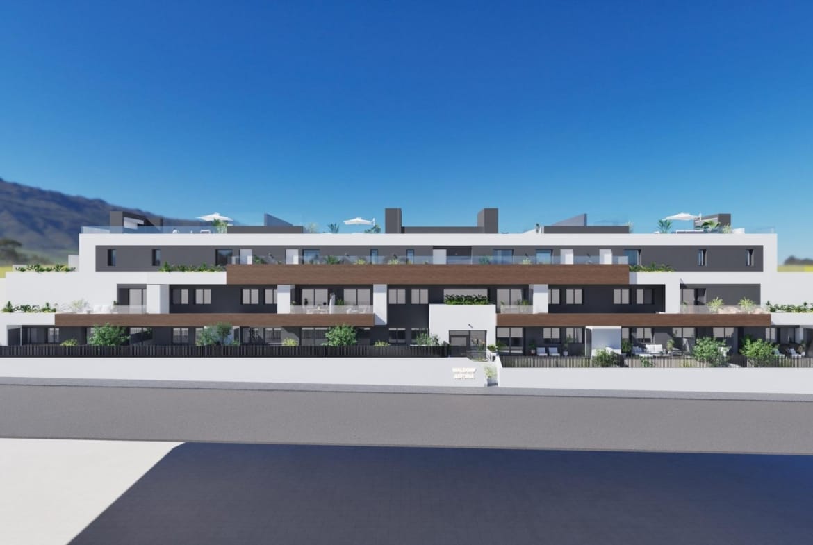 Modern three-story new build 3 bedroom apartment building with terraces in Benijofar, mountains in the background.