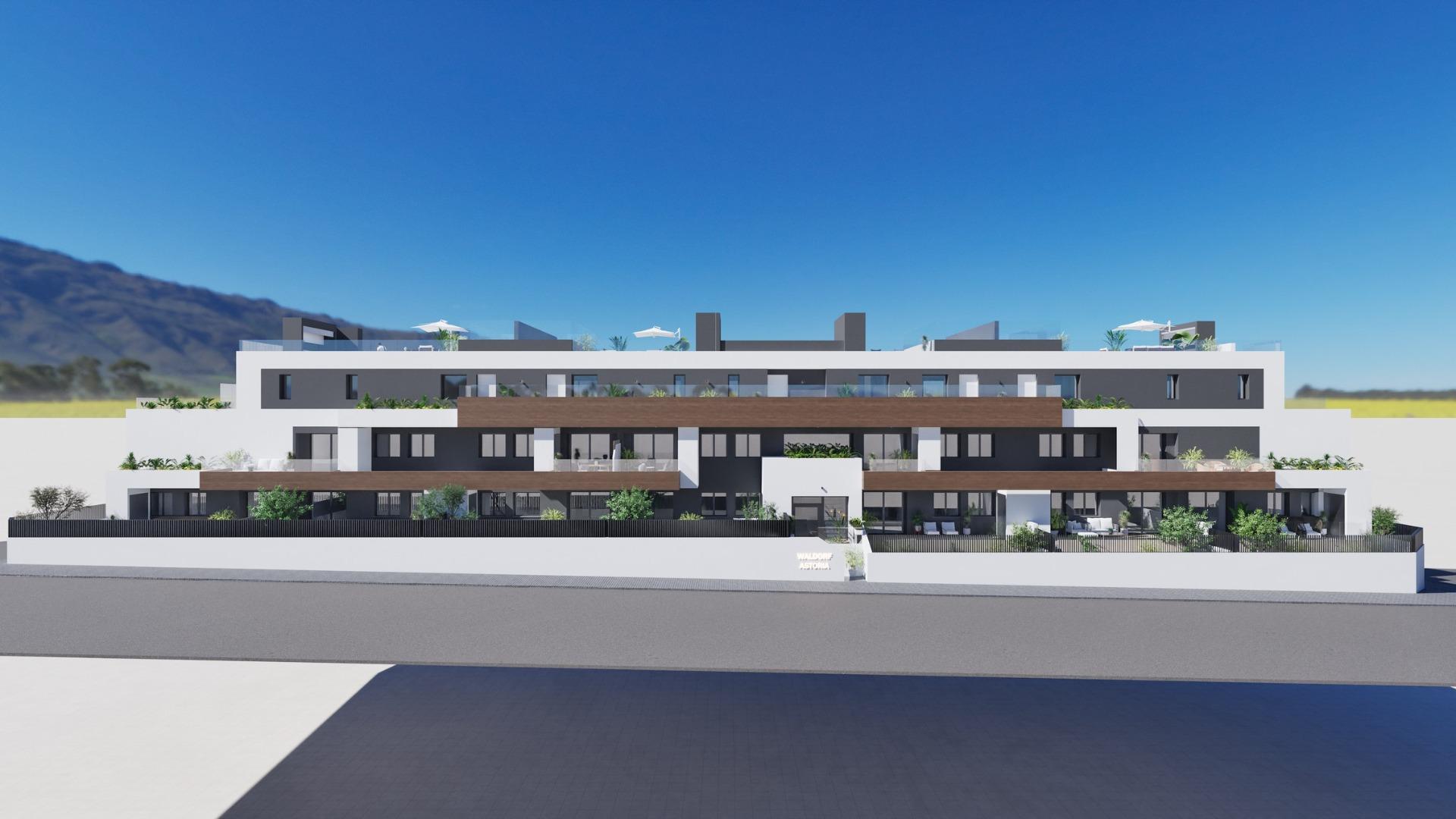 Modern white facade of a new build 2 bedroom ground floor apartment complex in Benijofar with mountain views.