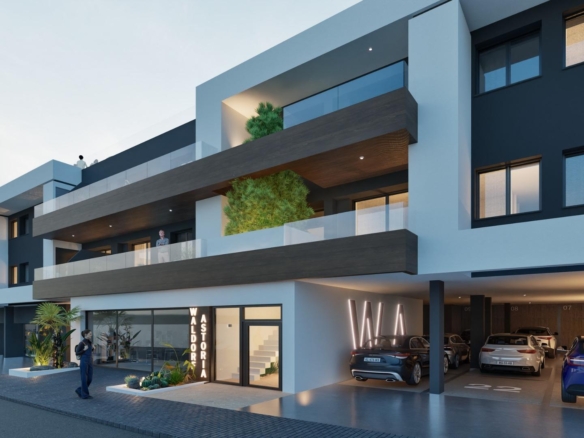 Modern exterior of a new build 2 bedroom apartment building with parking in Benijofar, Alicante at dusk.