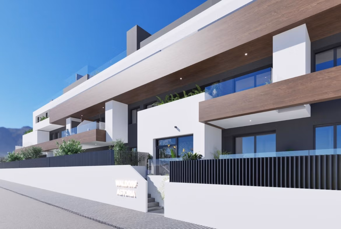 NEW-BUILD-RESIDENTIAL-IN-BENIJOFAR-2 Modern elevated 2-bedroom top floor apartment with balconies and wood accents in Benijofar under clear blue sky