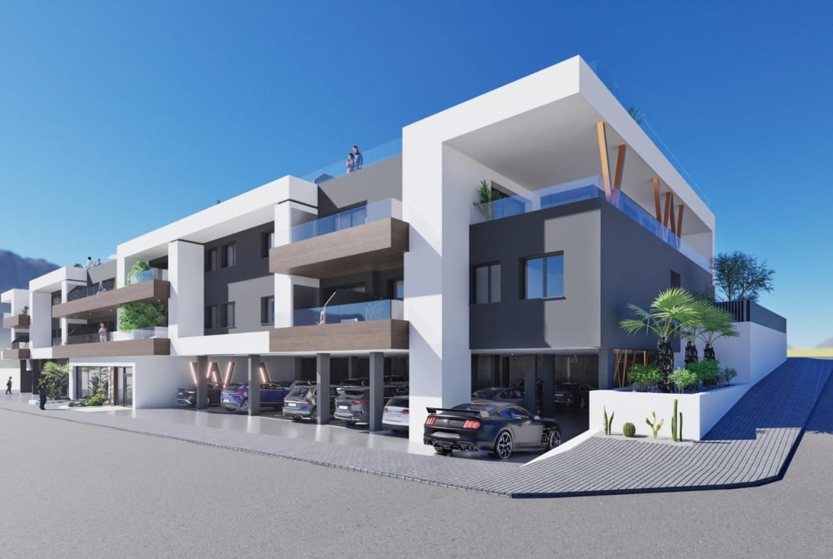 Modern new build 2 bedroom ground floor apartment building exterior with covered parking in Benijofar under clear blue sky