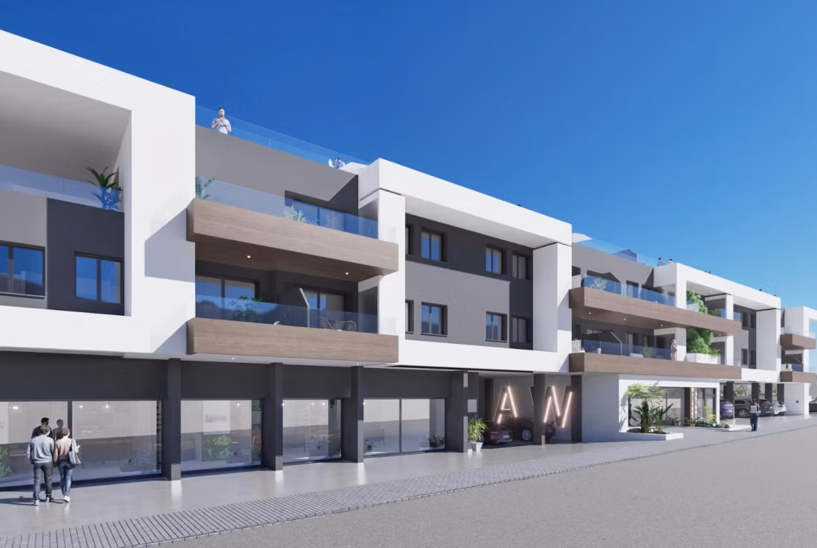 NEW-BUILD-RESIDENTIAL-IN-BENIJOFAR-3 Modern three-story building with balconies and storefronts, home to a new build 2 bedroom top floor apartment in Benijofar.