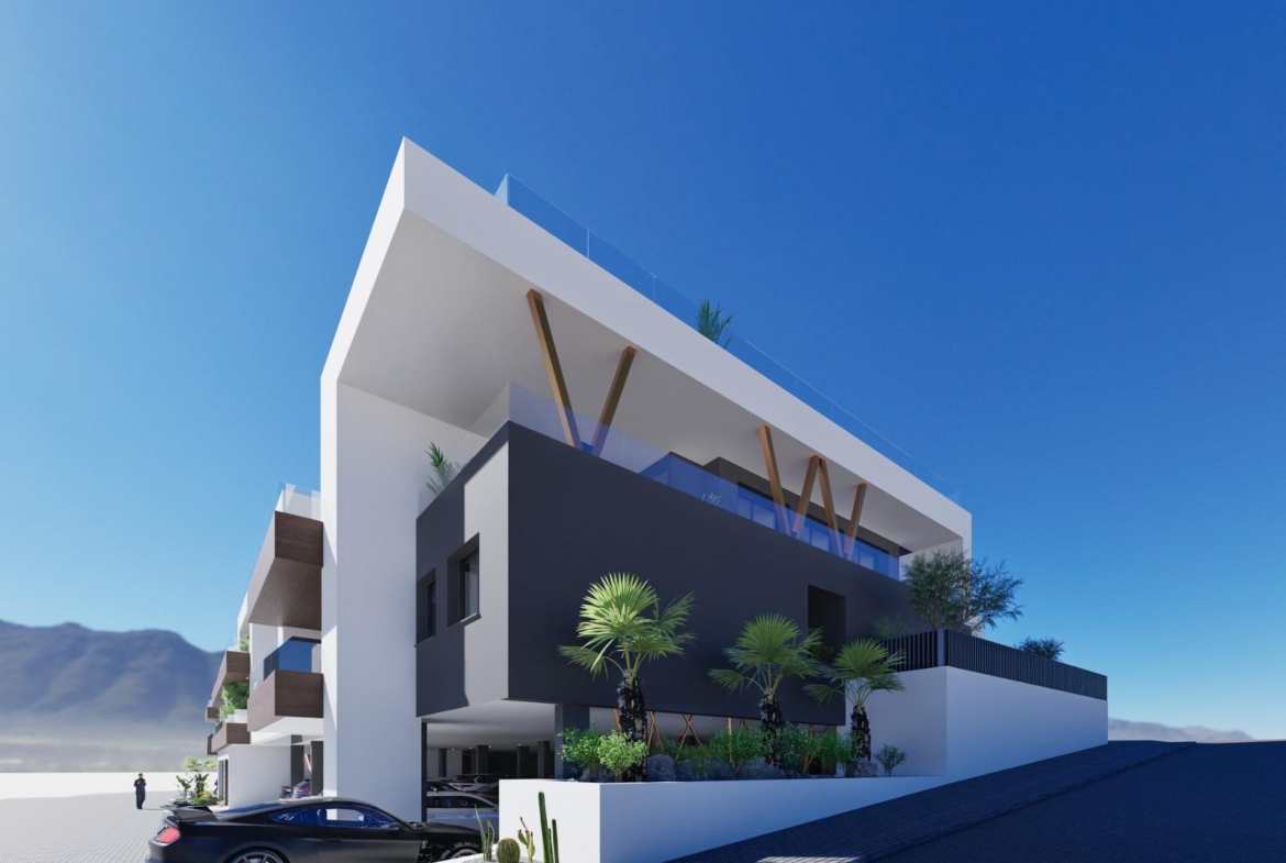 Modern exterior of a new build 2 bedroom ground floor apartment in Benijofar with balcony and parking area under clear sky.