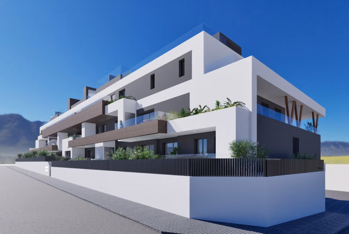 NEW-BUILD-RESIDENTIAL-IN-BENIJOFAR-7 Modern white and gray 2-bedroom top floor apartment with balconies and solarium in Benijofar against a clear blue sky and mountain backdrop