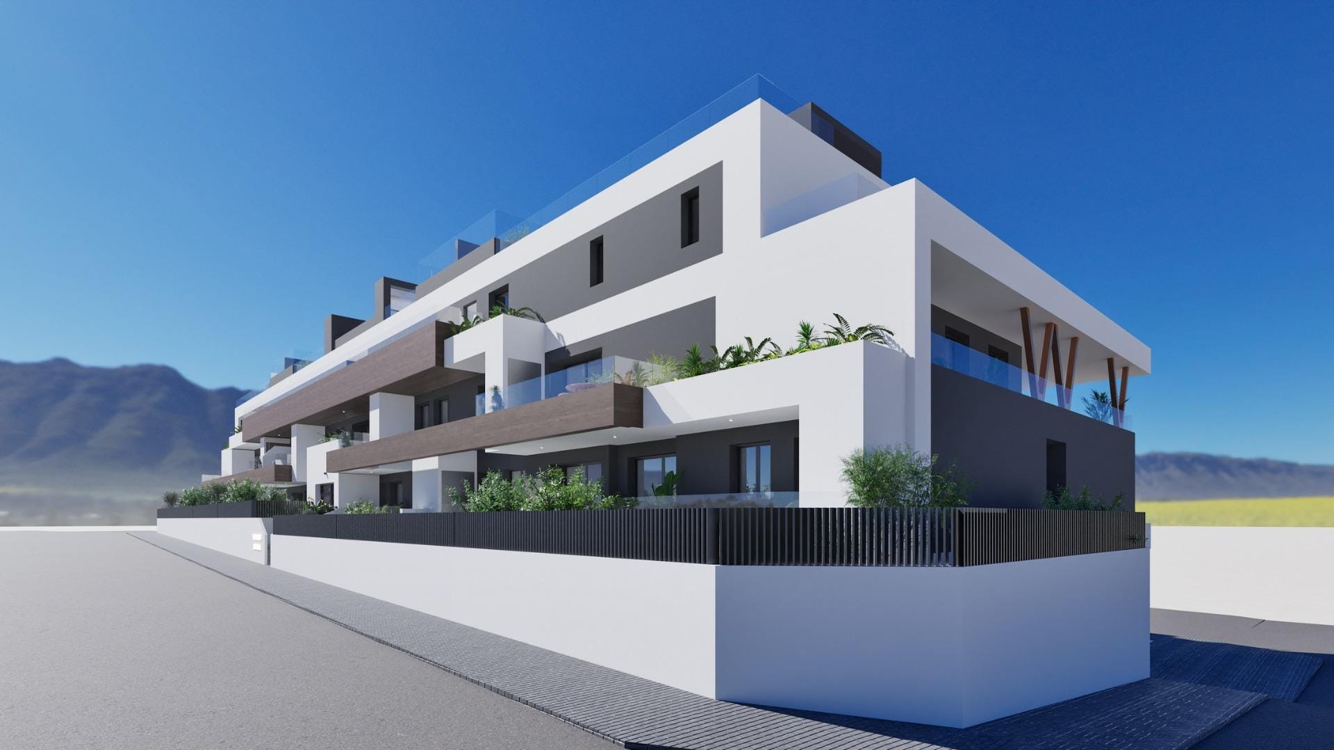 Modern white and gray 2-bedroom top floor apartment with balconies and solarium in Benijofar against a clear blue sky and mountain backdrop