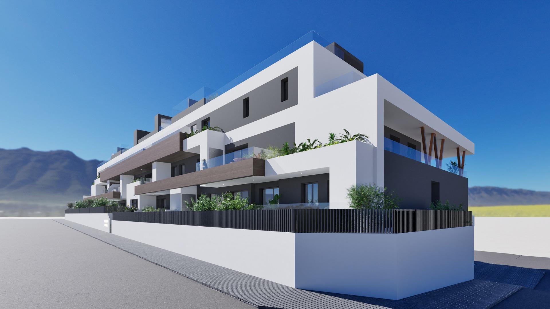 Modern white and gray new build 2 bedroom ground floor apartment exterior in Benijofar with terraced balconies and mountain backdrop.