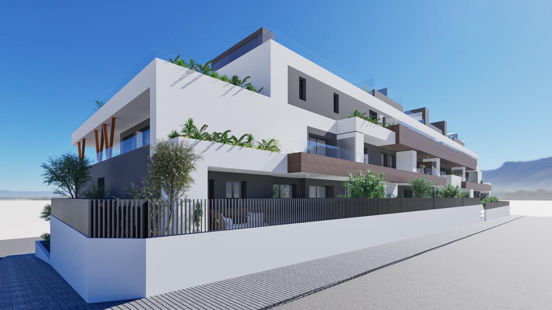 Modern exterior of a new build 2-bedroom ground floor apartment complex in Benijofar with balconies and greenery.