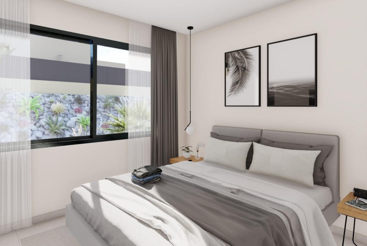 Bright bedroom with king-size bed and window in elegant new build villa in Altaona Golf Resort, Murcia