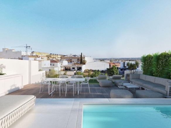 Spacious solarium with jacuzzi, seating area, and view over Benijofar rooftops in 2-bedroom penthouse new build