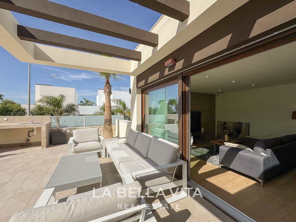 Sun-drenched terrace with elegant outdoor seating and sliding glass doors in a luxury single-storey villa, Benijófar, Costa Blanca