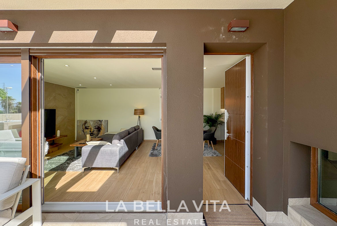 Sunlit, modern open-plan living area with sleek wooden floors in elegant single-storey villa in Benijófar, Costa Blanca.