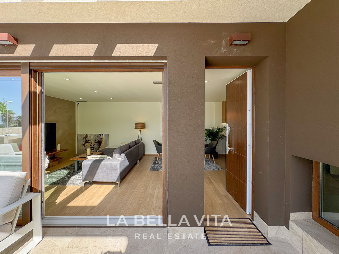 Sunlit, modern open-plan living area with sleek wooden floors in elegant single-storey villa in Benijófar, Costa Blanca.