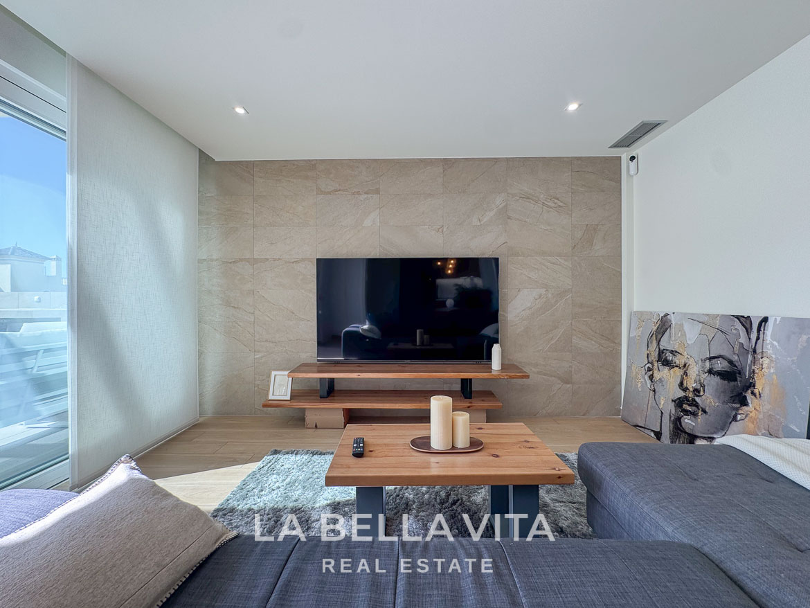Bright, modern living room with sleek TV wall and cozy seating in elegant single-storey new build villa, Benijófar, Costa Blanca