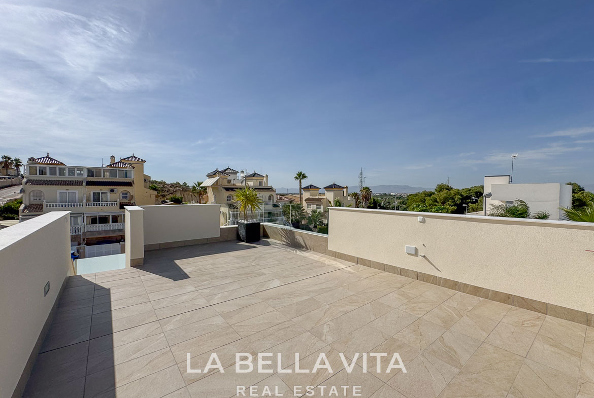 Spacious sunlit terrace with modern tiled flooring and scenic views in elegant single-storey villa, Benijófar, Costa Blanca.