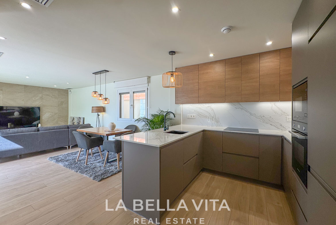 Modern open-plan kitchen and living area with sleek cabinetry and natural light in elegant single-storey villa, Benijófar, Costa Blanca