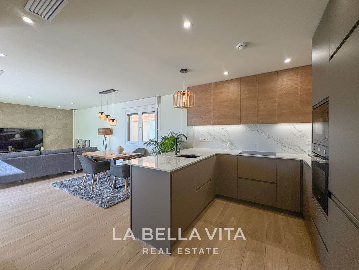 Modern open-plan kitchen and living area with sleek cabinetry and natural light in elegant single-storey villa, Benijófar, Costa Blanca