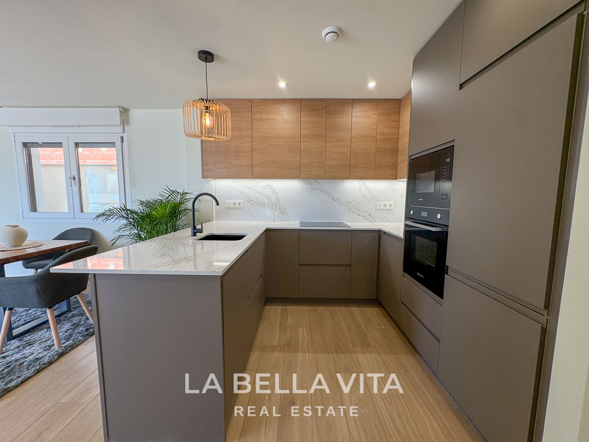 Modern, sleek kitchen with marble countertops and wood accents in elegant single-storey villa in Benijófar, Costa Blanca