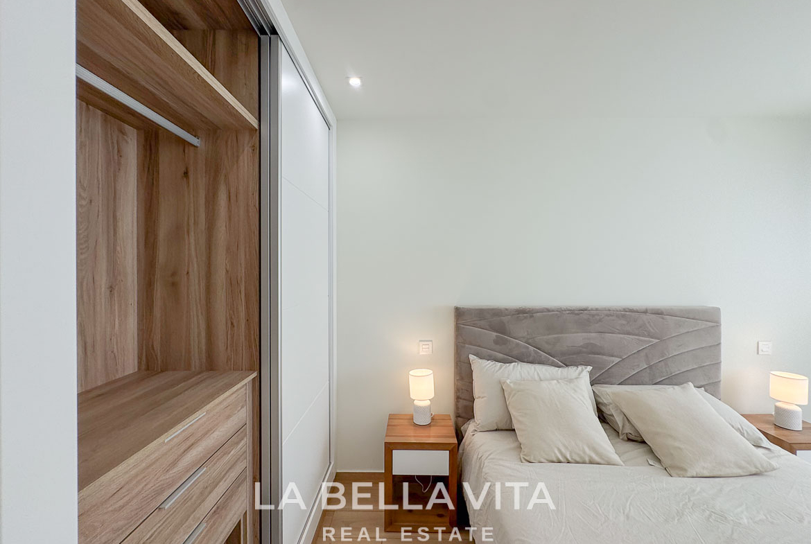 Bright and elegant bedroom with modern wood wardrobe in a single-storey new build villa in Benijófar, Costa Blanca