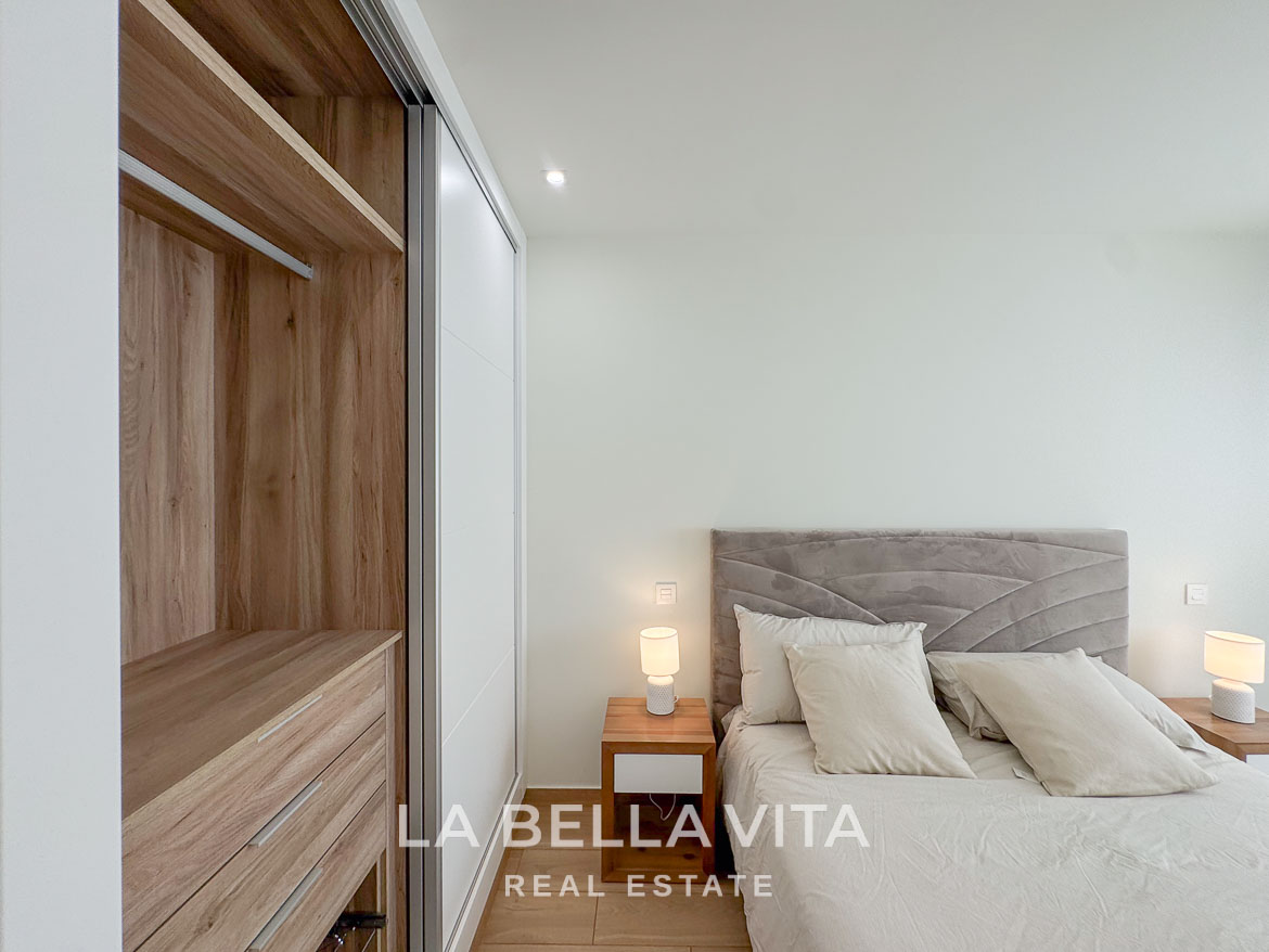 Bright and elegant bedroom with modern wood wardrobe in a single-storey new build villa in Benijófar, Costa Blanca