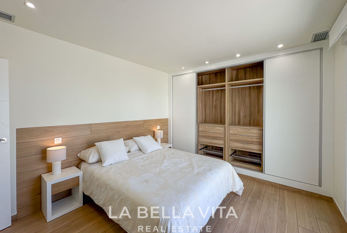 Bright elegant bedroom with modern built-in wardrobe in a luxury single-storey new build villa in Benijófar, Costa Blanca