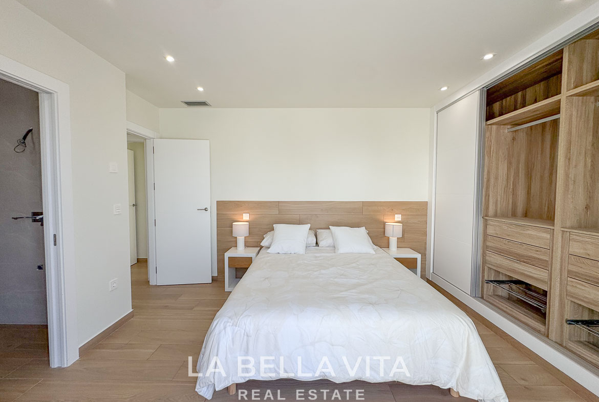 Bright and elegant bedroom with modern wooden flooring and built-in wardrobes in luxury single-storey villa, Benijófar, Costa Blanca