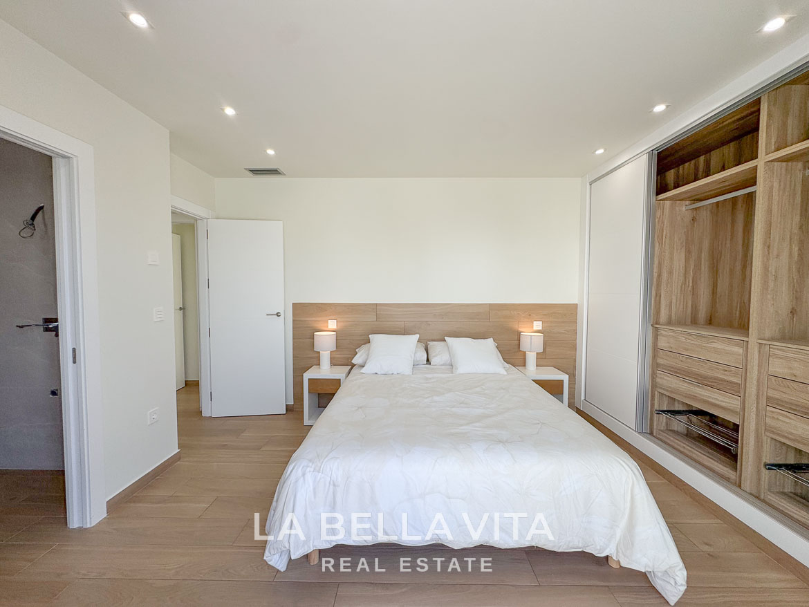 Bright and elegant bedroom with modern wooden flooring and built-in wardrobes in luxury single-storey villa, Benijófar, Costa Blanca