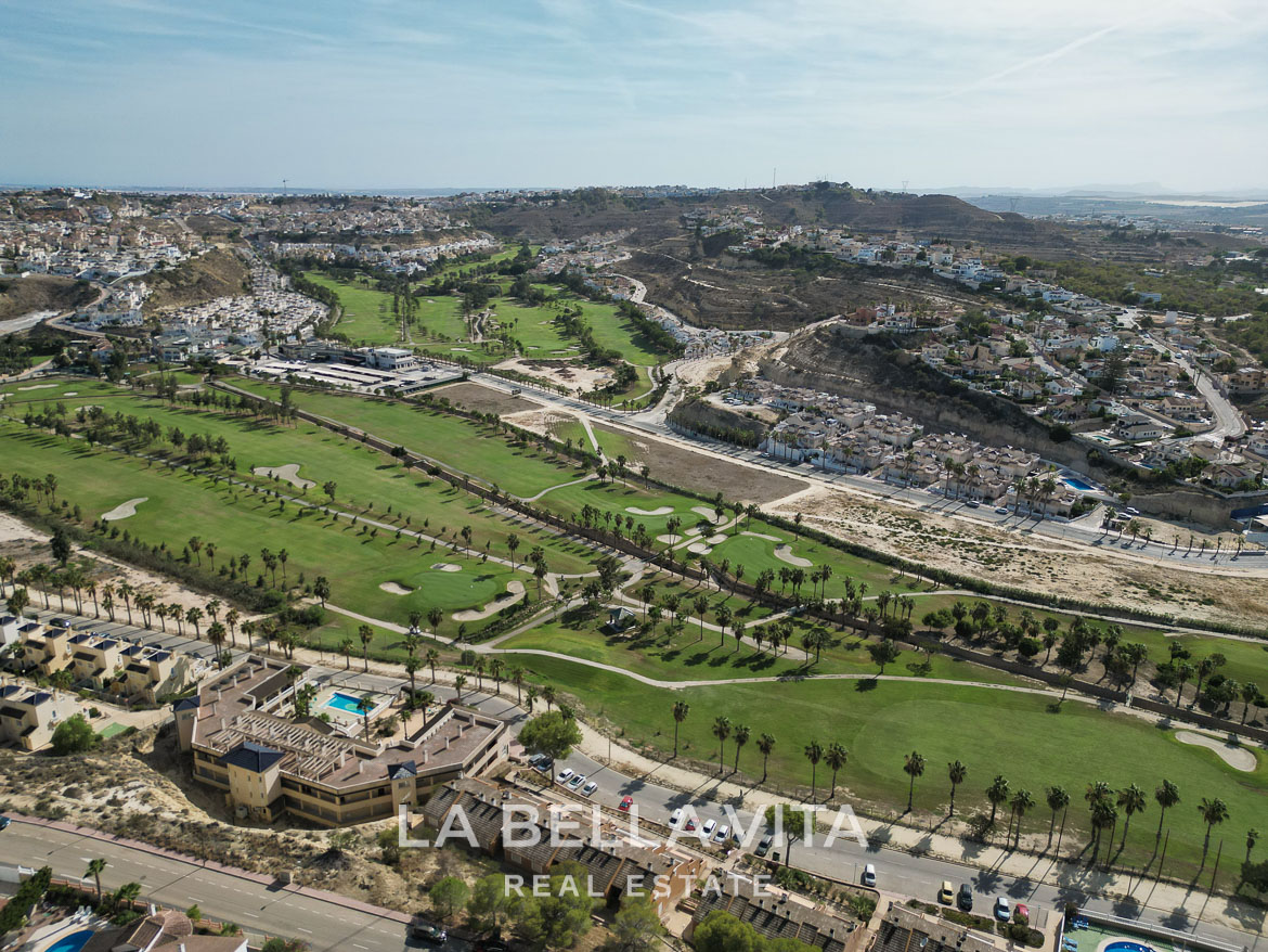 Stunning aerial view of an elegant single-storey villa with private pool overlooking lush golf course in Benijófar, Costa Blanca.