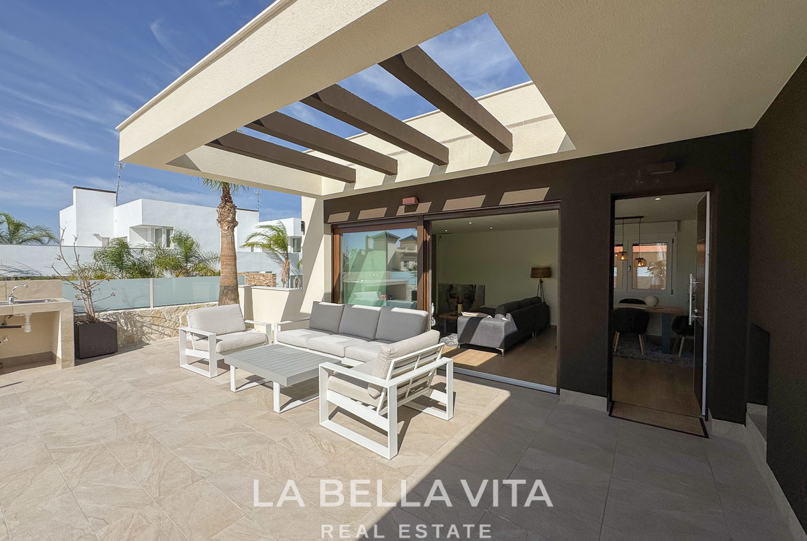 Spacious sunlit terrace with modern outdoor seating and sleek interiors of elegant single-storey villa in Benijófar, Costa Blanca