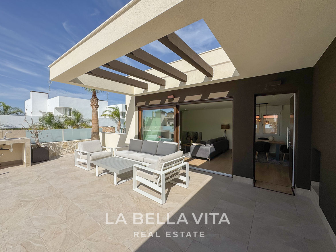 Spacious sunlit terrace with modern outdoor seating and sleek interiors of elegant single-storey villa in Benijófar, Costa Blanca