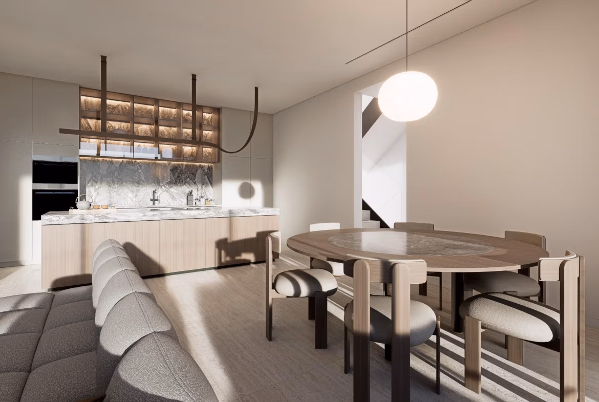 Modern dining area and kitchen in a luxury villa at Las Colinas Golf Resort with natural light and contemporary furnishings.
