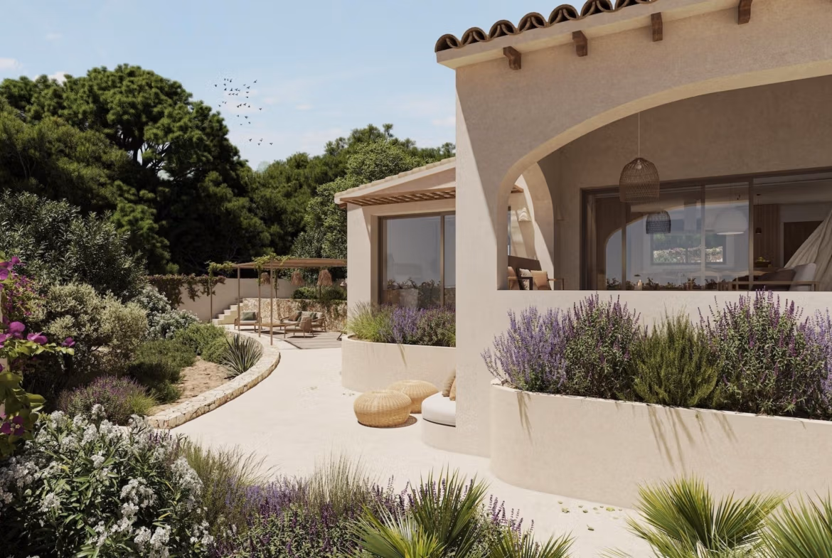 Elegant single-storey villa exterior with curved terrace, lush landscaping, and serene garden in La Fustera, Benissa.