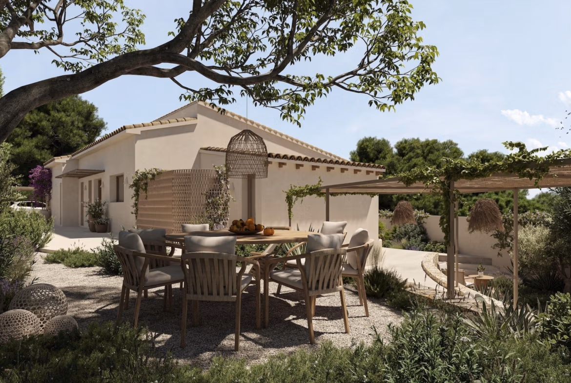 Elegant outdoor dining terrace with natural landscaping at refined new build single-storey villa in La Fustera, Benissa